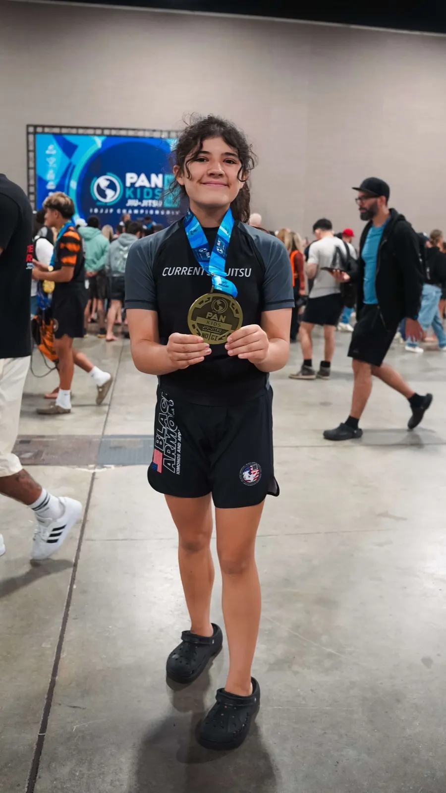 Student with medal at PAN Kids Championship